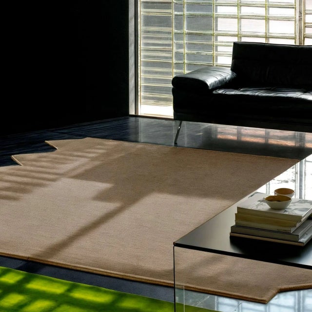 The Moody Red Rug features triangular shapes along the border in deep burgundy, evoking passion, strength, and bold...