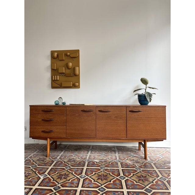 Sideboard released by the british brand avalon. the beautiful teak veneer combined with the elegant, rounded handles gives...