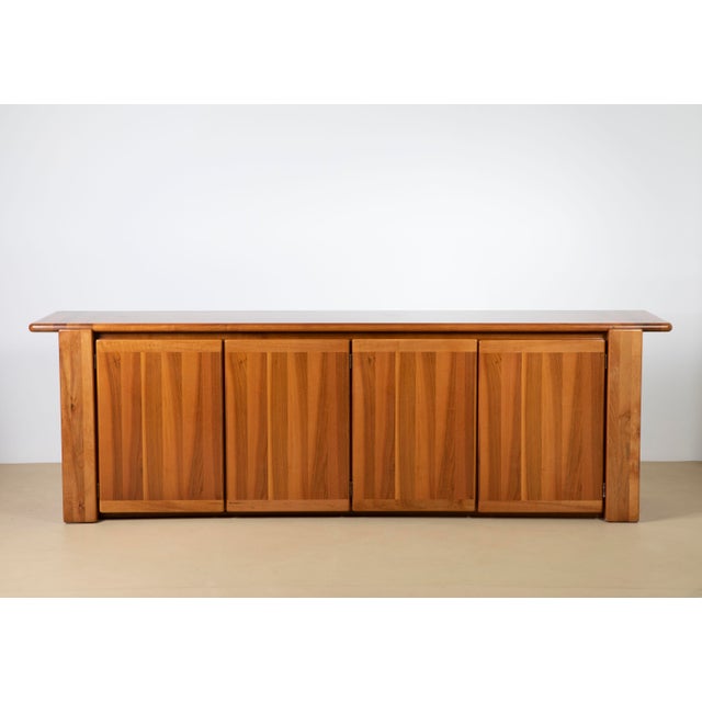 An exceptional and highly substantial modernist sculptural walnut sideboard (credenza), manufactured by the prestigious...
