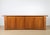An exceptional and highly substantial modernist sculptural walnut sideboard (credenza), manufactured by the prestigious...