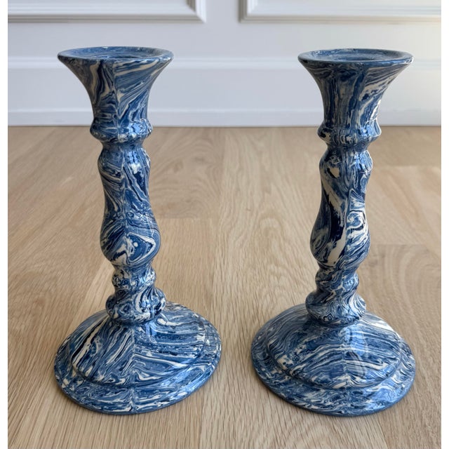A striking pair of vintage blue and white marbleized ceramic candlesticks featuring richly swirled agateware / Aptware...