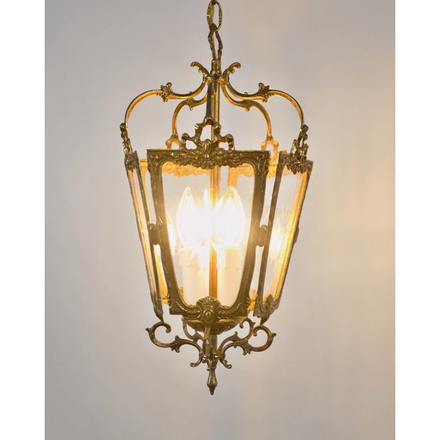 Decorative hanging lantern made of brass, made in a historicist style with richly shaped ornaments, plant motifs and...