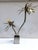 Modular luminous palm tree in chromed and golden metal. The light comes from the two lamp holders placed inside the vase,...