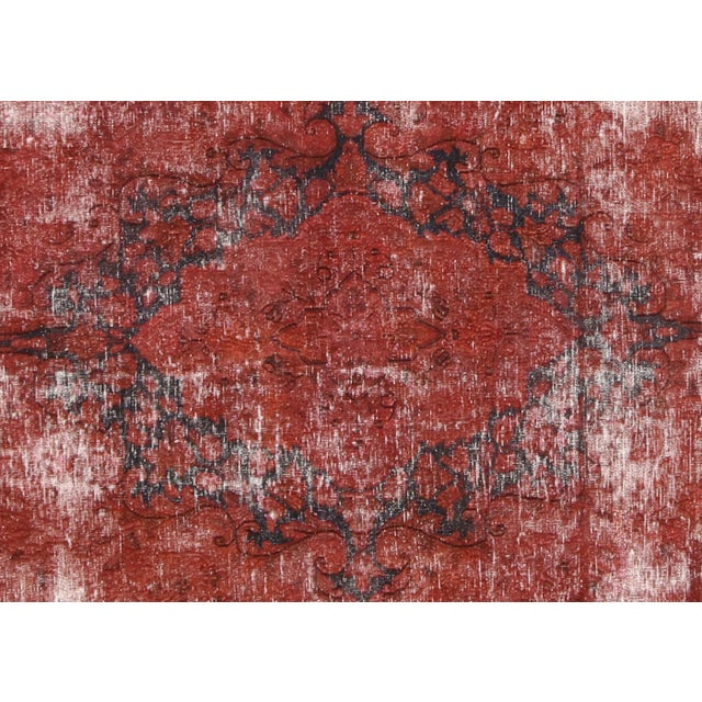 This Vintage Persian Kerman Overdyed Rug, hand-woven with wool on a cotton foundation in Iran, has been refinished and...