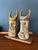 Whimsical pair of ceramic viking faces on a wood base created by artist Hal Fromhold. Art piece includes a hand-written...