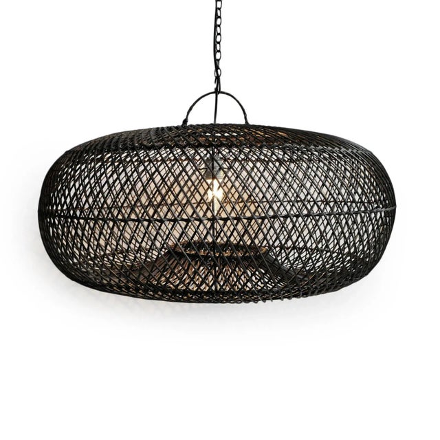 Hand crafted black finish wicker donut shaped lantern in medium size. Each may have slight variations in handmade...