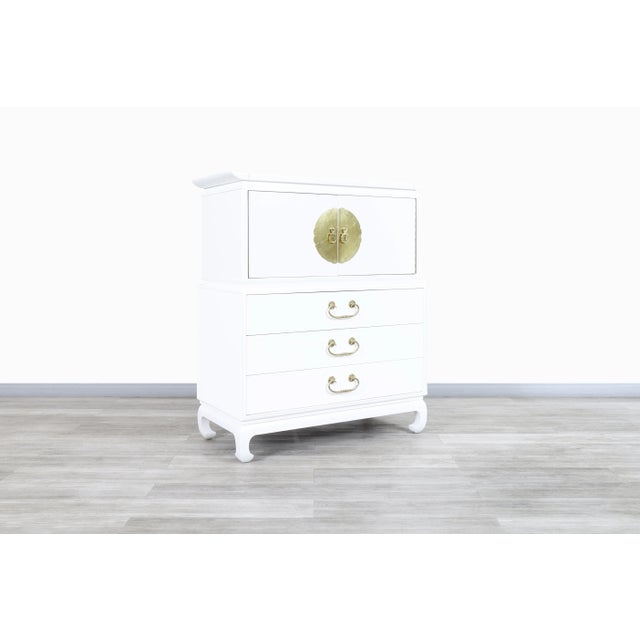This stunning vintage Hollywood Regency highboy dresser, crafted in the United States during the 1950s, is a beautiful...