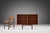 This Mid-century cabinet is made of veneer teak wood, a warm material that exudes natural charm. The cabinet has delicate...