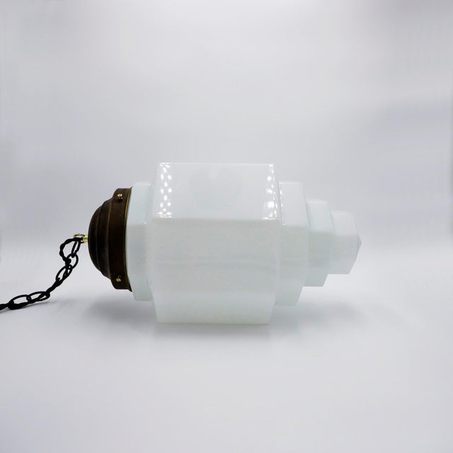 Circa 1930. We offer this Big Size Art Deco Milk Glass Skyscraper Pendant Light. This lamp can match with 2 others that we...