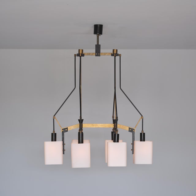 Italian ceiling light dating from the 1950s, characterized by an architectural mid-century composition in brass, black...
