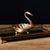 This vintage-style storage tray features an aged gold finish and a graceful swan shape—the swan's body forms the tray's...