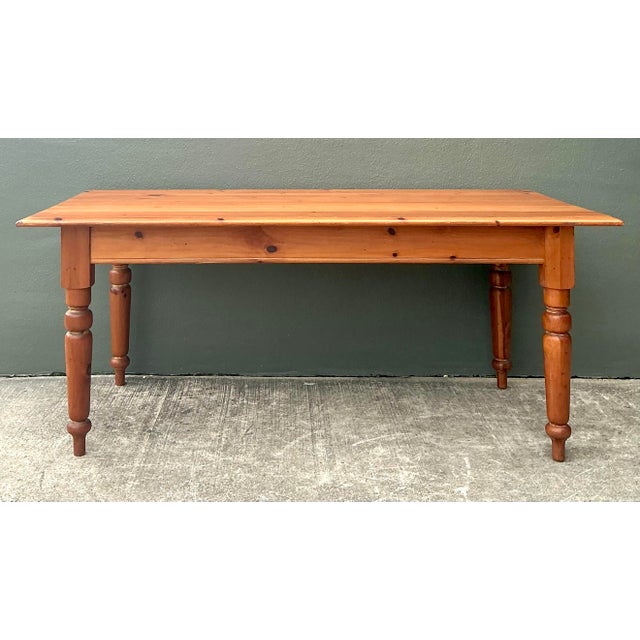 Embrace the rustic elegance of this vintage knotty pine farm table, a piece that balances traditional craftsmanship with...