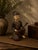 This expressive hand-carved Chinese wooden figural sculpture depicts a seated musician holding a stringed instrument,...