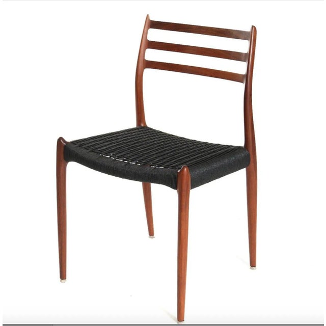 Rare 'horn' dining chairs made of solid teak, designed in the 1950s by Niels Otto Møller and produced by J. L. Møller...