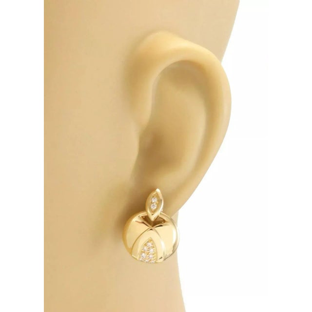 This lovely authentic pair of earrings are by Movado, they are crafted from 18k yellow gold featuring a marquise shape top...