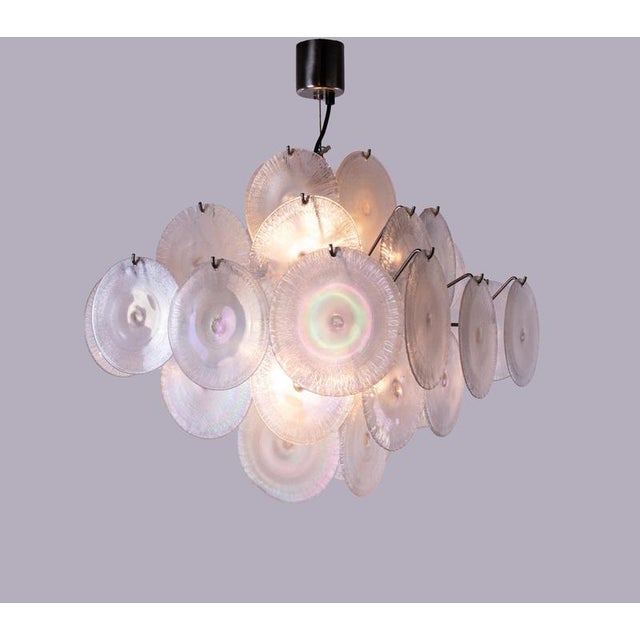 Elegant chandelier with iridescent, pearl-like discs with crinkled edges arranged on five levels on a chromed sputnik...