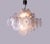 Elegant chandelier with iridescent, pearl-like discs with crinkled edges arranged on five levels on a chromed sputnik...