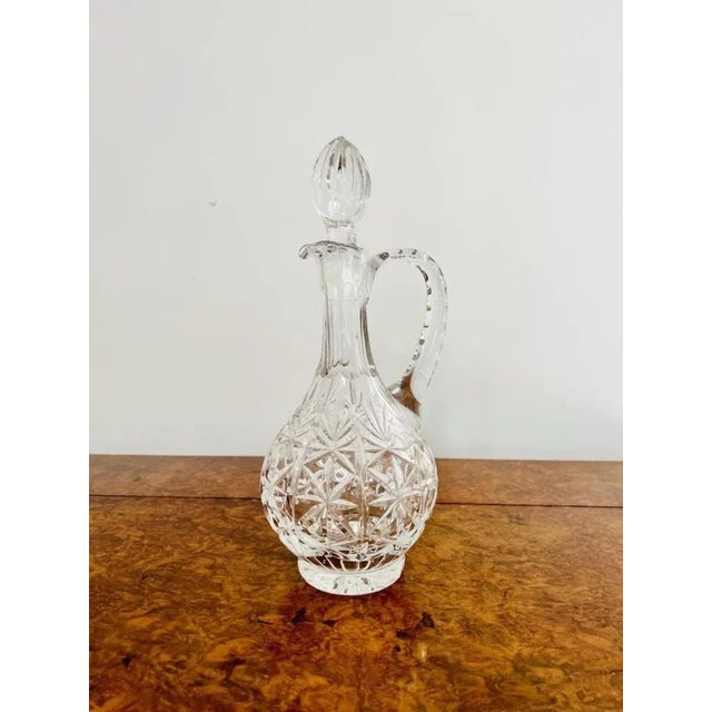 Stunning quality antique Edwardian cut glass ewer having a quality antique Edwardian cut glass ewer with a shaped handle...
