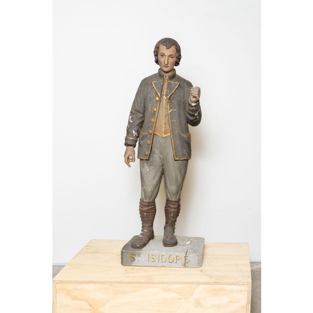 A beautiful antique devotional statue depicting Saint Isidore the Laborer, patron saint of farmers, agricultural workers,...