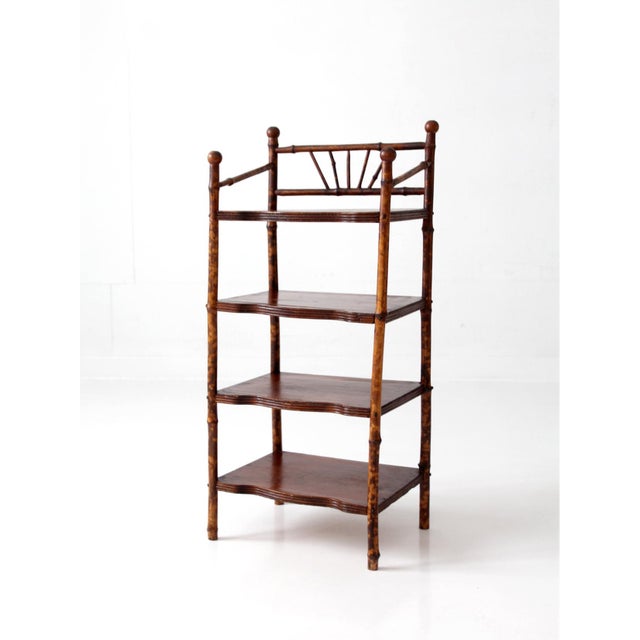 This antique bamboo étagère dates to the late 19th to early 20th century and features four tiered shelves with shaped...
