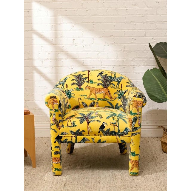 A fantastic vintage postmodern lounge chair with a sculptural barrel silhouette and bold yellow jungle-print upholstery....