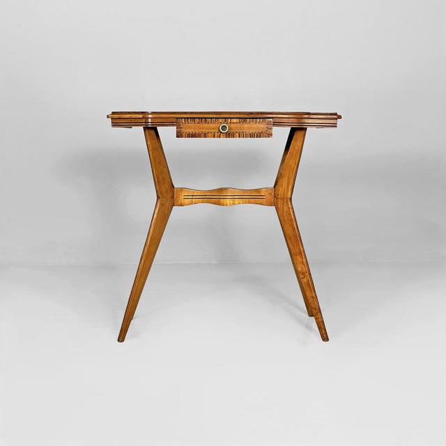 Italian Art Deco console table in veneered wood, dating from the 1940s. This elegant and refined piece features a...