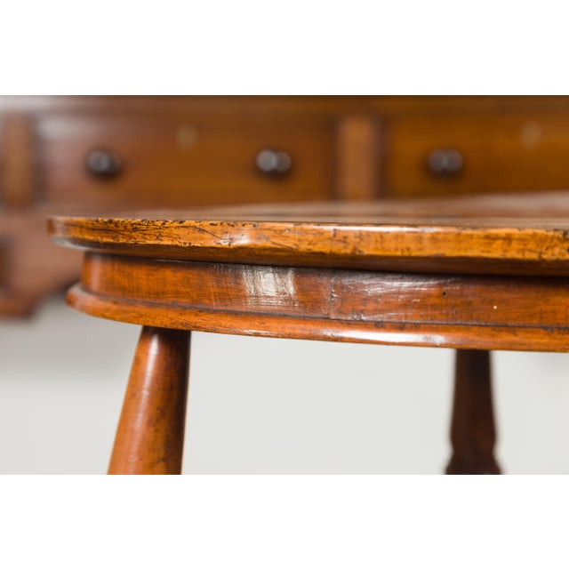 An unusual English cricket table from the mid-19th century, with circular sycamore top and cross-stretcher. Born in...