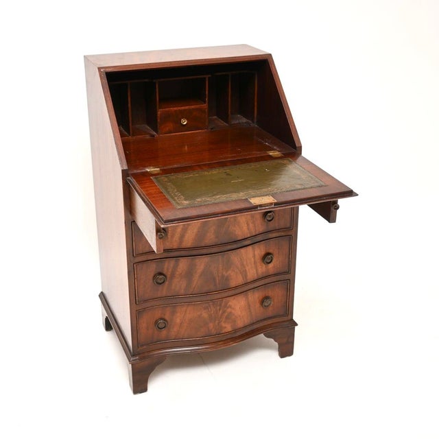 A smart and useful antique Georgian style writing bureau. This was made in England, it dates from around the 1950’s. The...