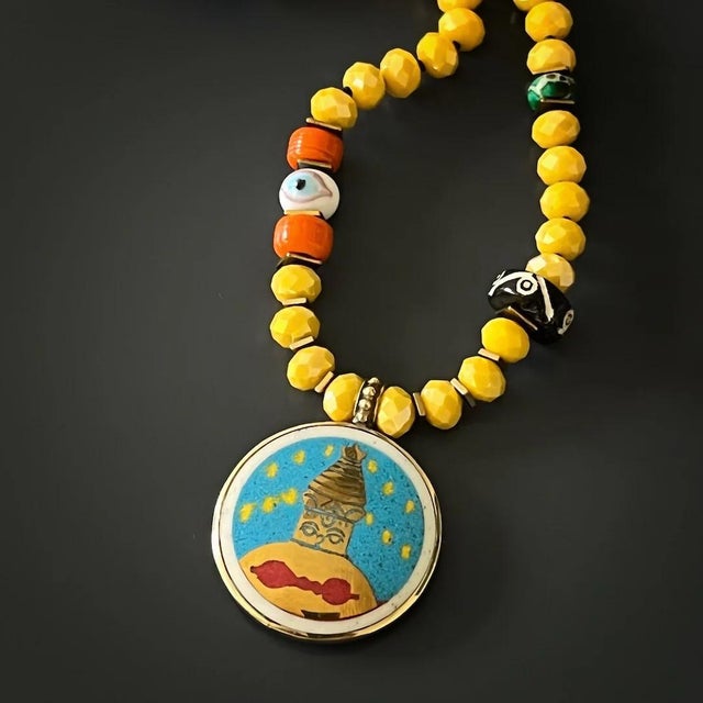 The Colorful Nepal Mantra Pendant Yellow Beaded Long Necklace is the perfect piece to brighten up your life. Perfect for...