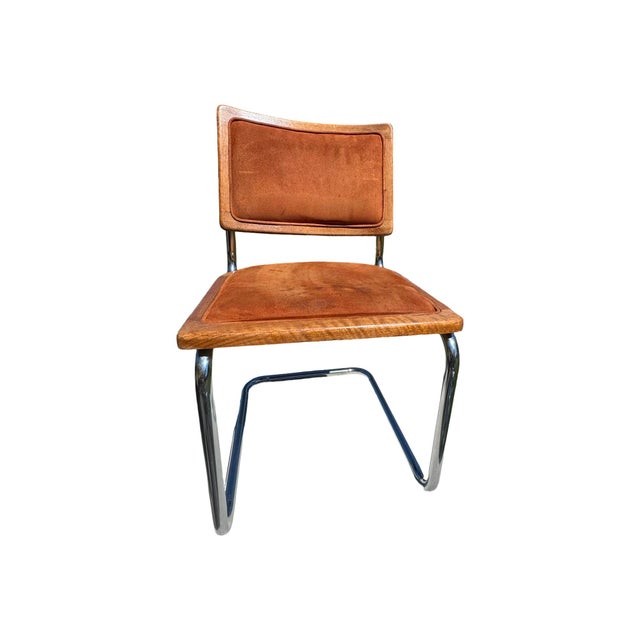Striking set of four vintage 1970s Mid-Century Modern dining chairs featuring sculpted oak frames, warm cognac suede...