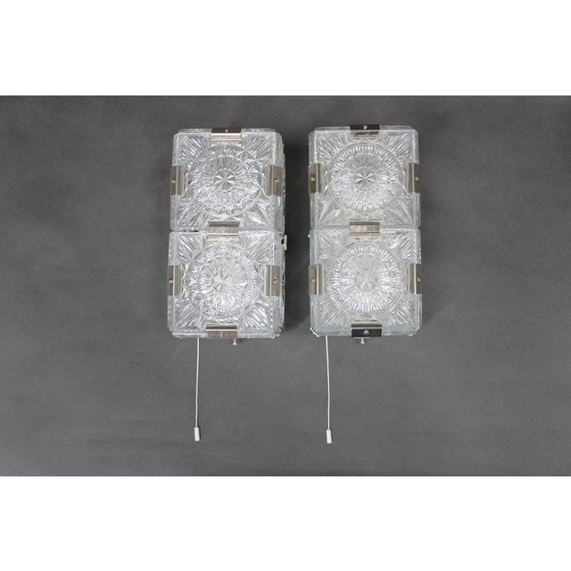 This refined pair of mid century wall lights was produced in czechoslovakia in the 1970s by the celebrated glassworks...