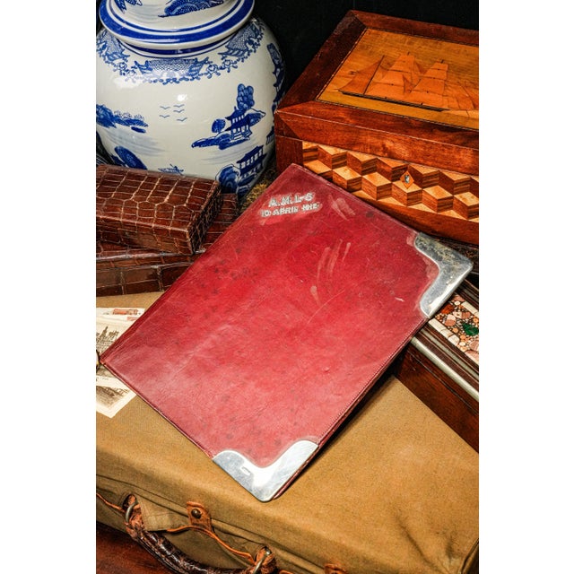 Infuse your workspace with timeless elegance and historical intrigue with this antique dark burgundy leather desk folio,...