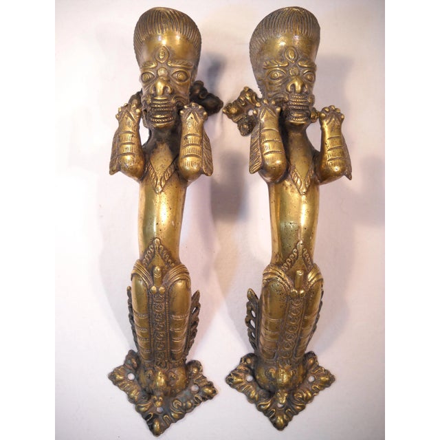 A truly unique and fabulous pair of antique Indian deity bronze door pulls. Each door handle is in itself a work of art....