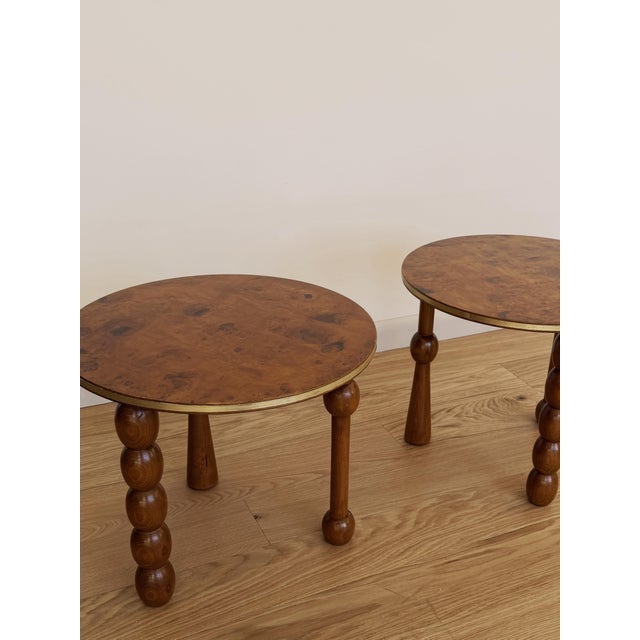 Unusual burlwood drink table featuring a round top with brass banding and distinctive turned legs. The warm burlwood grain...
