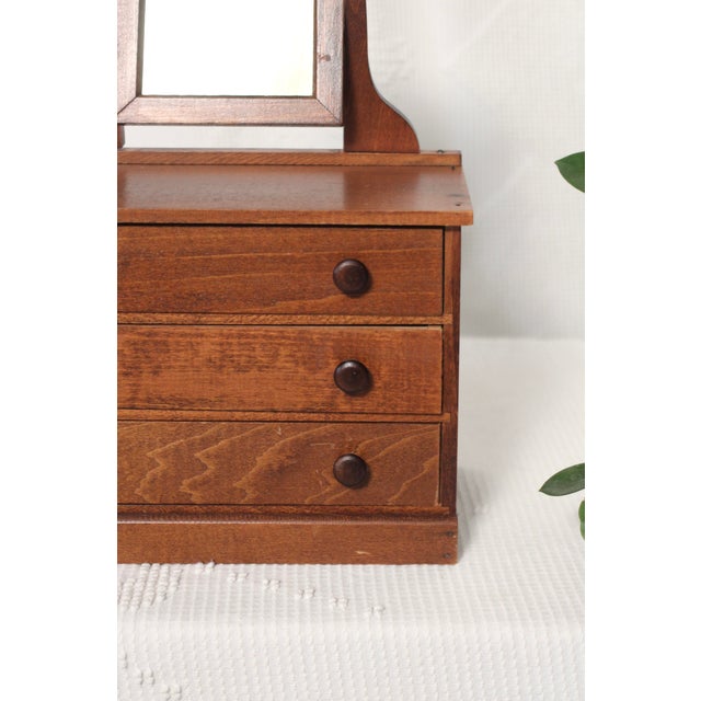 A beautiful smaller wooden dresser with 3 drawers and a hinged mirror on top. Similar to larger furniture but in a smaller...