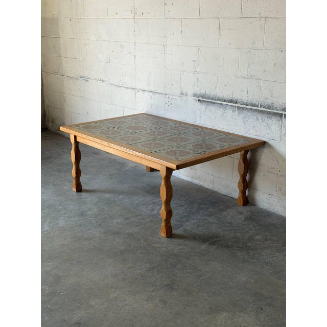 This striking coffee table features an inset ceramic tile top with intricate patterns and sturdy turned legs. Crafted in...