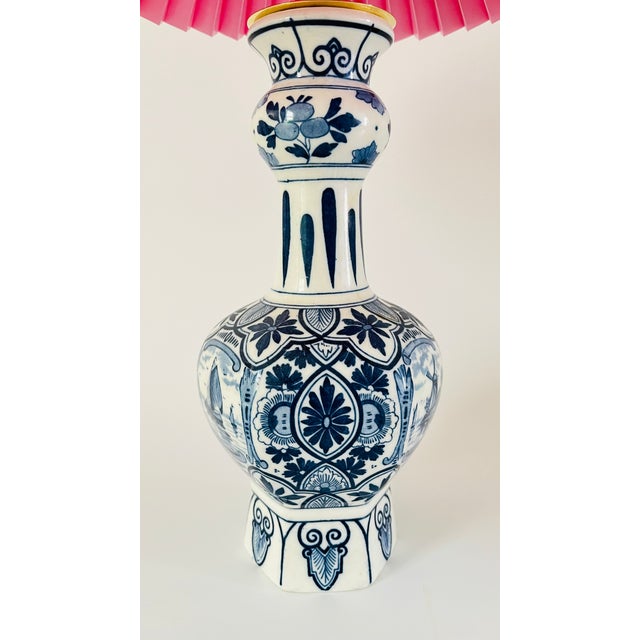 A 20th century Delft vase lamp, in a classic garlic neck shape. Decorated in blue and white with two different prints: two...