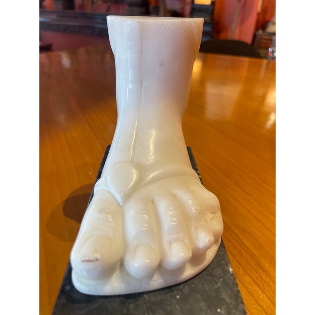 Exceptional Italian mid century marble foot on pedestal base in the style of Fornasetti.