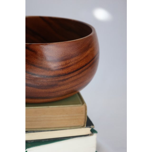 This dainty yet hearty fruits bowl is crafted from a lovely two-toned teak, and sits at 13 cm tall with a base width of...