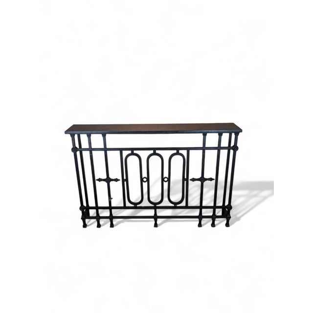 Handmade, dark patina'd wrought iron console table with with black stone top. Dimensions: Stone: 59"w x 3/4"h x 9 3/4"d....