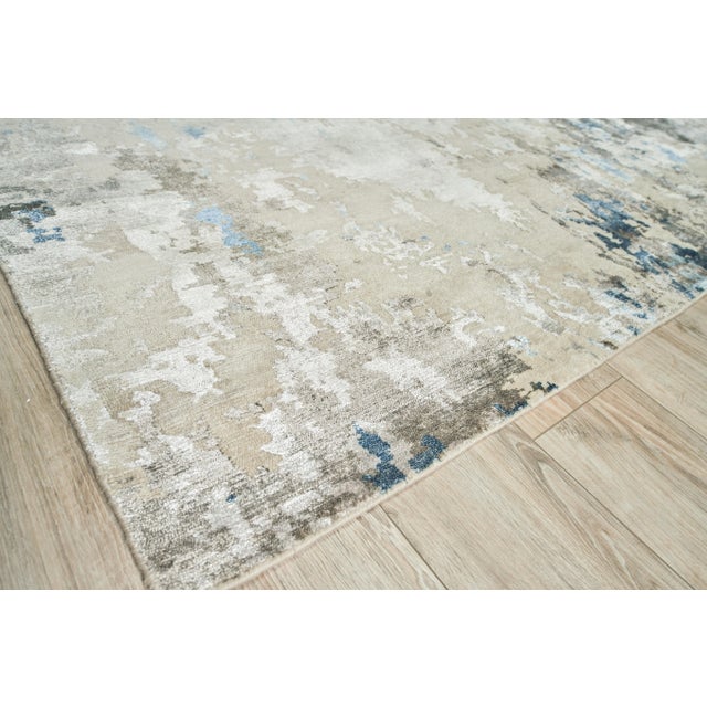 The Cosmo rug is hand knotted and artfully designed of wool and shimmering accents of Bamboo Silk. This remarkable...