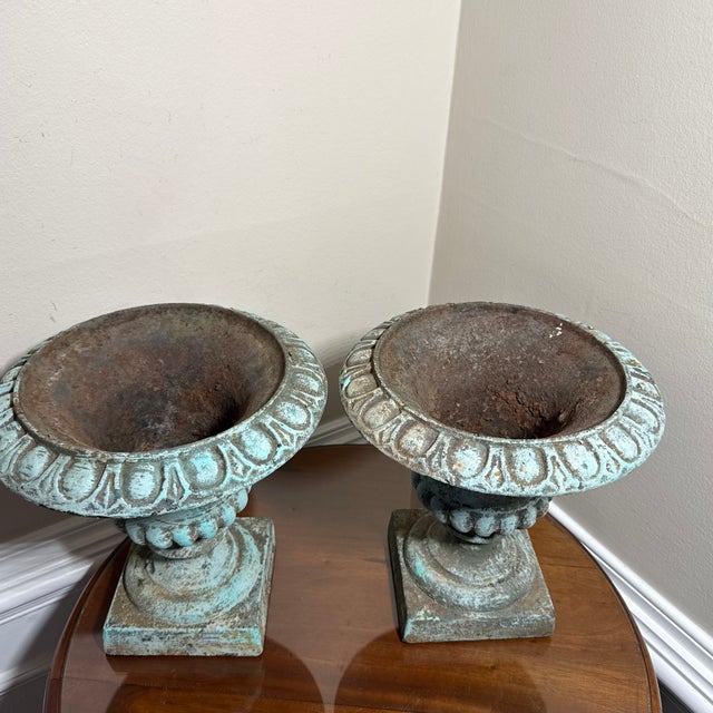 stunning vintage pair of French Country-style cast iron garden urn planters. Featuring a beautifully aged verdigris green...