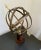Patina'd brass and walnut armillary with a central ring with engraved Roman numeral detailing. A quality decorative item...