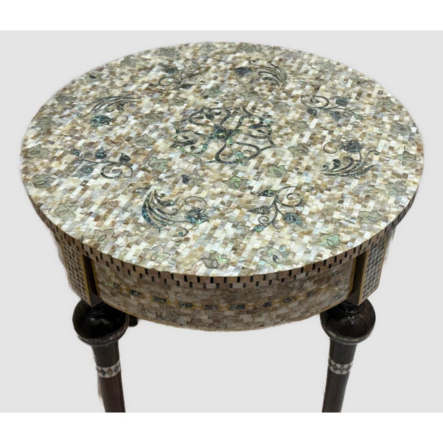 Elevate your space with this handmade round side table crafted from solid wood and fully inlaid with natural mother of...