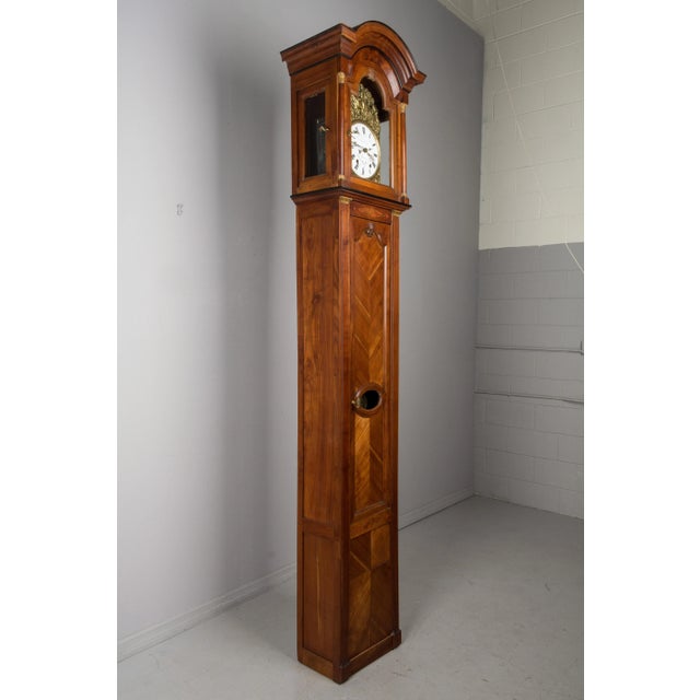 A 19th century French Horloge de Parquet or tall case clock from Brittany. Elegant solid cherry case in two parts, with...