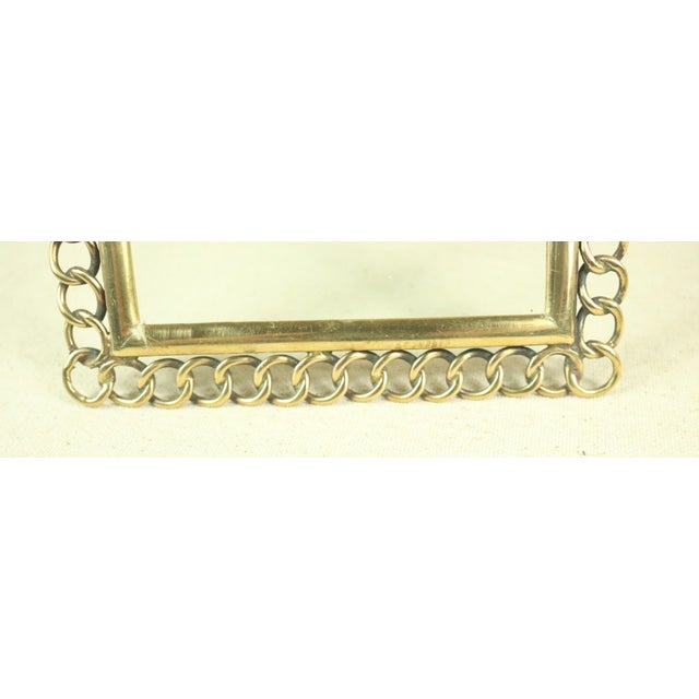 A late 19th century English photo frame with a brass chain link motif. This style of frame is often referred to as a...