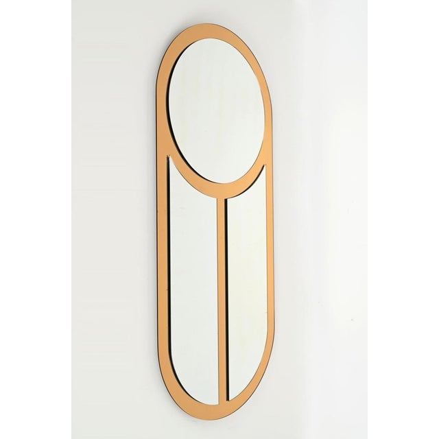 Wonderful large Mid-Century oblong mirror made in a combination of bronzed and clear mirrors. This incredibly unique and...