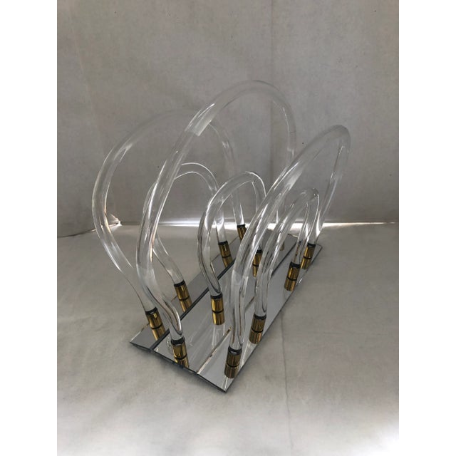 Great vintage lucite magazine rack with accents of gold color by Dorothy Thorpe in perfect condition.