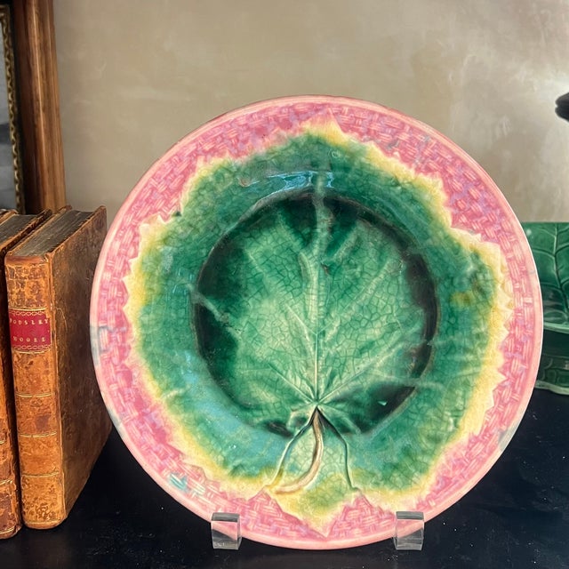 Majolica wall plate with a pink basketweave border and green maple leaf in the center. Made by Griffin, Smith & Hill in...