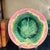 Majolica wall plate with a pink basketweave border and green maple leaf in the center. Made by Griffin, Smith & Hill in...